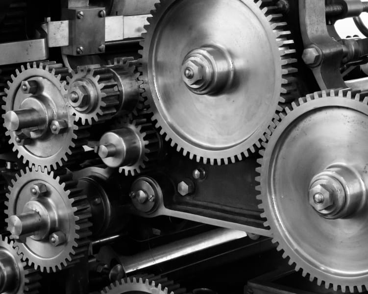 Close-up of interconnected metal gears in machinery.